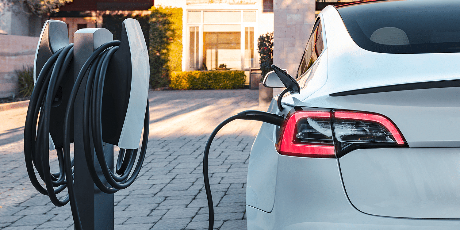 Tesla electric vehicle charging at a Tesla Destination Charger station